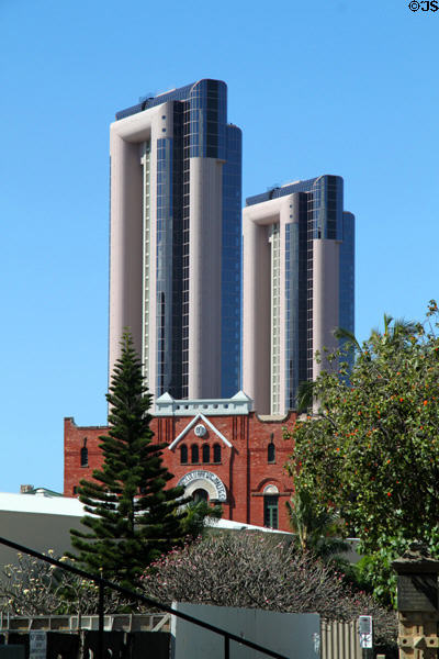 One Waterfront Towers over Honolulu Brewing & Malting Co. building. Honolulu, HI.