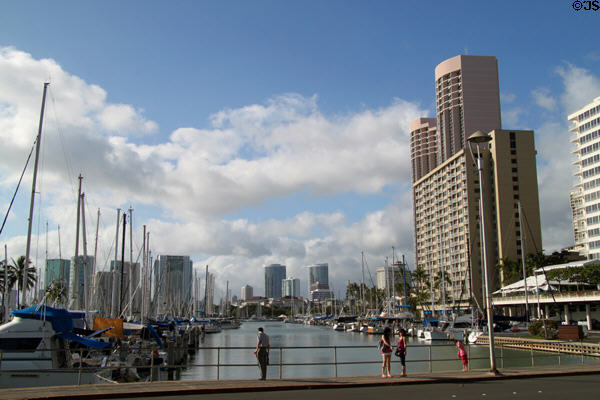 Waikiki Yacht Harbor at mouth of Ala Wai Canal with twin Prince Hotel towers. Waikiki, HI.