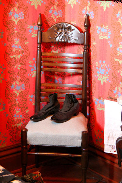 Ladder-back chair with high-button boots at Dodge House. Council Bluffs, IA.