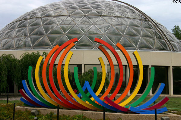 Geodesic dome of Des Moines Botanical Center behind rainbow sculpture (1984) of Christiane T. Marteno. Des Moines, IA.