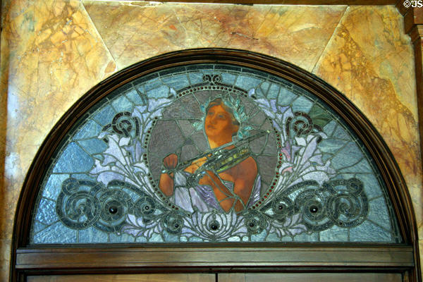 Stained glass window of woman playing violin over entrance of Auditorium Building. Chicago, IL.