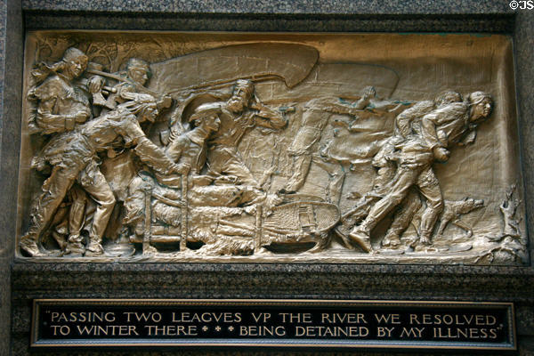 Bronze relief of Marquette being portaged by native Americans 