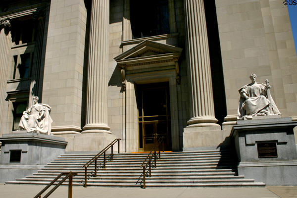 Seated statues flanking corner entrance of US Court House & Post Office. Indianapolis, IN.