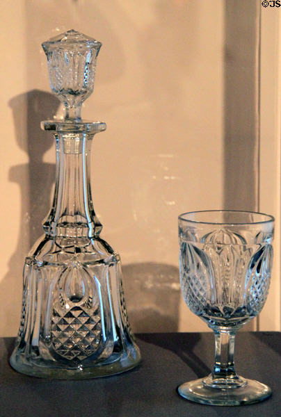 New England Pineapple pattern glass decanter (1850-70) by Boston & Sandwich Glass Co. plus pressed lead glass goblet (c1860) at Wichita Art Museum. Wichita, KS.