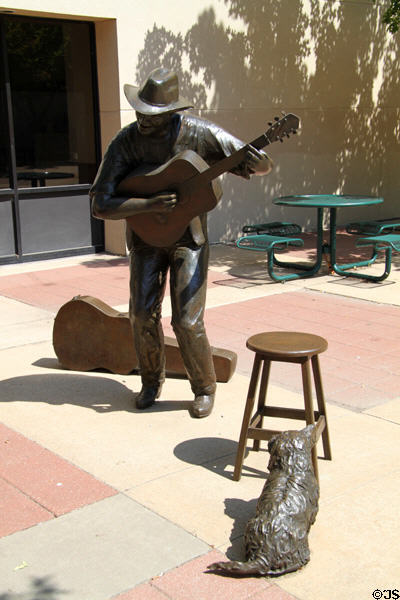 Sculpted man playing guitar (2000) by Georgia Gerber in Reflection Square Park on Douglas Street. Wichita, KS.