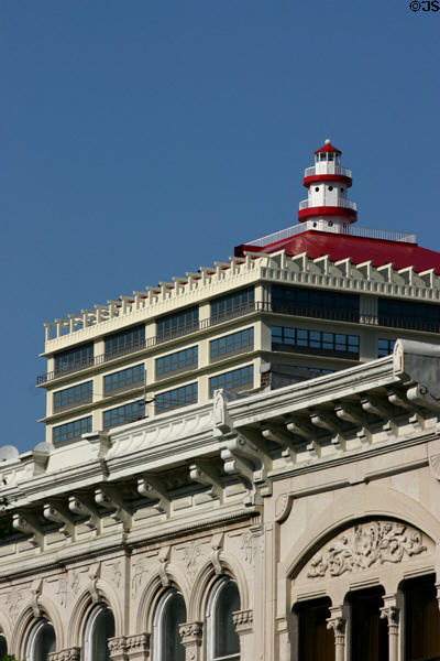 Victorian buildings on 5th St. towered over by modern highrise with lighthouse-like tower. Louisville, KY.