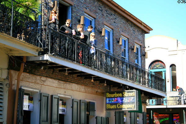 People taking in Bourbon Street scene. New Orleans, LA.