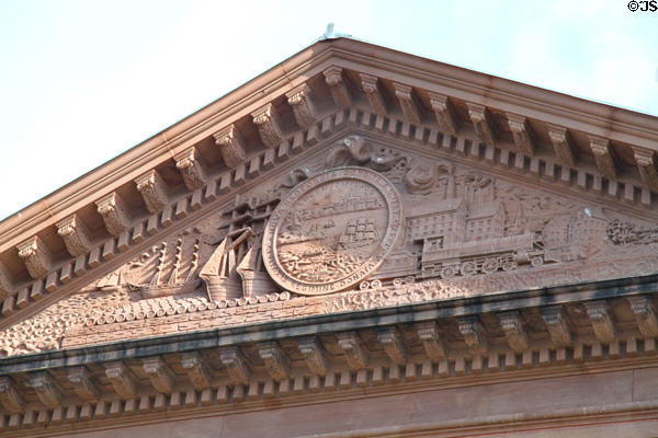 Town seal with sailing ships, rail & factory carvings in pediment of New Bedford City Hall. New Bedford, MA.