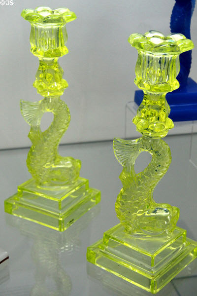 Pressed glass dolphin candlesticks (1845-75) by Boston & Sandwich Glass Co. at Sandwich Glass Museum. Sandwich, MA.