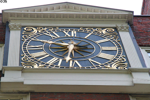 Clock on wall of Massachusetts Hall of Harvard College. Cambridge, MA.