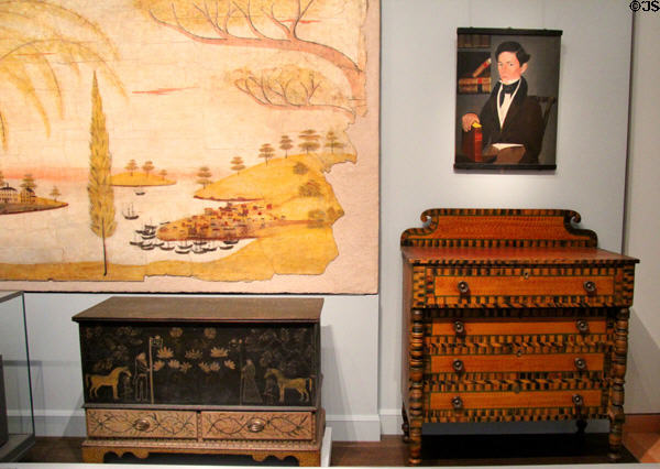 Two painted chests with drawers (c1840-60) from NY or PA & (1830-50) from Northern New England emulating expensive inlaid wood under portrait at Museum of Fine Arts. Boston, MA.