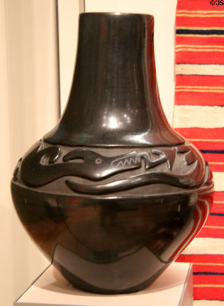 Earthenware water jar with polished black slip (c1963) by Margaret Tafoya (potter) & Alcario Tafoya (carver) of Santa Clara Pueblo, NM at Museum of Fine Arts. Boston, MA.