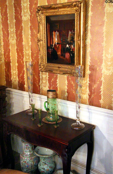 Side table with glass & painting in music room at Gibson House Museum. Boston, MA.
