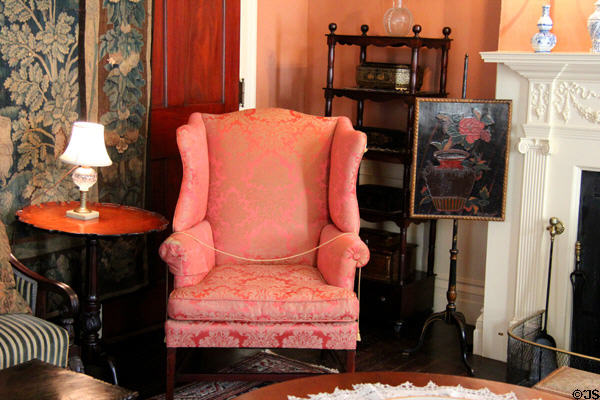 Wing chair beside parlor fireplace at Nichols House Museum. Boston, MA.