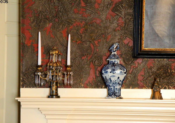 Dining room mantle with girandole, ginger jar & original Japanese leather wallpaper (1885) made of layers of embossed paper at Nichols House Museum. Boston, MA.