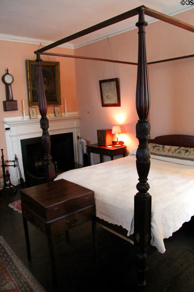 Third-floor rear bedroom with American four-poster bed (early 1800s) & "Beau Brummell" box (early 19thC) from London at Nichols House Museum. Boston, MA.