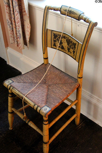Hitchcock side chair with caned seat as stenciled by Rose Standish Nichols in rear bedroom at Nichols House Museum. Boston, MA.