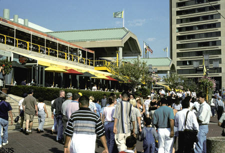 People stroll along Pratt Street Pavilion on revitalized harbor quays. Baltimore, MD.