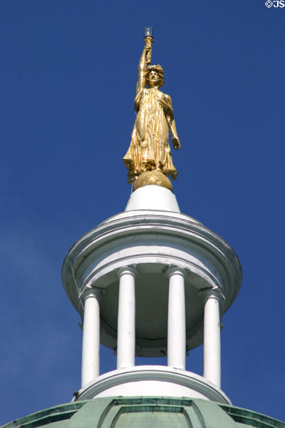 Golden figure of Wisdom with lantern by W. Clark Noble on State Capitol. Augusta, ME.