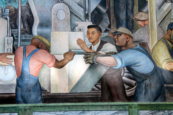 Workers moving auto parts on north wall of Detroit Industry Murals by Diego Rivera at Detroit Institute of Arts. Detroit, MI.