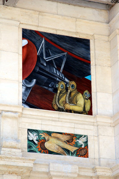 Soldiers in gas masks with aircraft over hawk of war on west wall of Detroit Industry Murals by Diego Rivera at Detroit Institute of Arts. Detroit, MI.