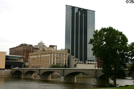Amway Grand Plaza Hotel (1983) rises above Grand River. Grand Rapids, MI. Architect: Marvin DeWinter.