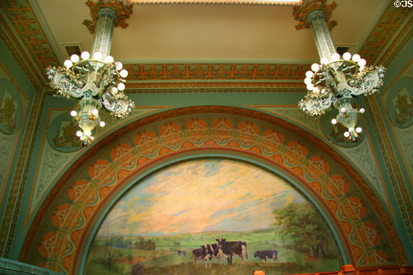 Wall with arch, mural & Sullivanesque bronze chandeliers in National Farmer's Bank. Owatonna, MN.