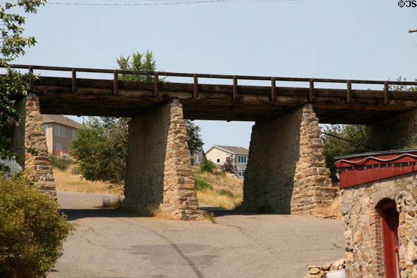 Morelli Bridge [aka Howie St. Bridge] at Reeder's Alley (1893) on stone piers with timber deck. Helena, MT.