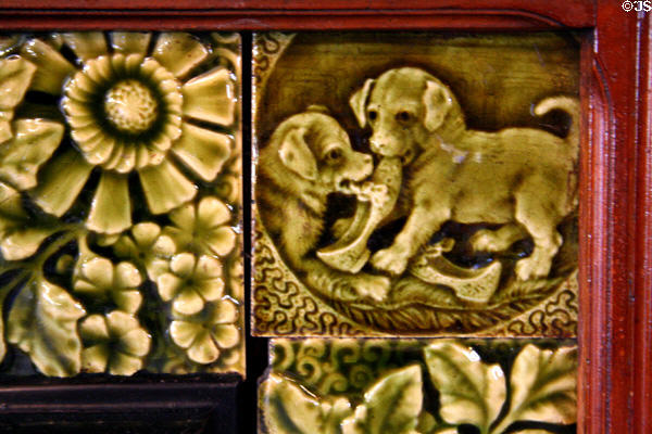 Tile with dogs chewing slippers at Mansion on the Hill. Ogallala, NE.