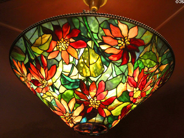 Stained glass lamp shade (poinsettia pattern) (1914) by Louis Comfort Tiffany of New York City at Currier Museum of Art. Manchester, NH.