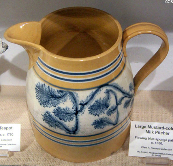 Mustard colored milk pitcher with flowing blue sponge pattern (c1850) at Woodman Museum. Dover, NH.