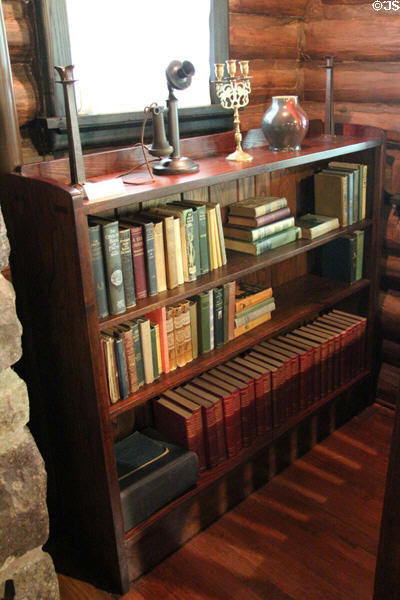 Arts & Crafts book case (c1910-11) by Craftsman Workshops of Eastwood, NY & objects including candle stick telephone at Stickley Museum at Craftsman Farms. Morris Plains, NJ.