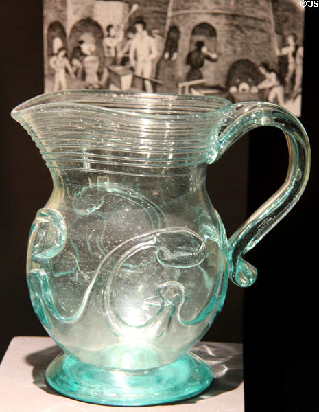 Green glass lily pad pitcher (mid 19thC) prob. from New York at Museum of American Glass. Milville, NJ.
