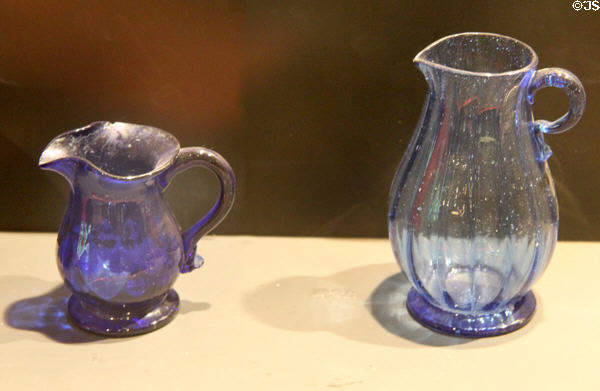 Blue glass cream pitcher (early 19thC) prob. Pittsburgh (l) American or English (r) at Museum of American Glass. Milville, NJ.