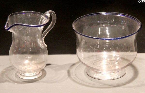 Clear glass creamer & bowl with blue glass rims (early 19thC) prob. New England at Museum of American Glass. Milville, NJ.