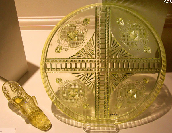 Vaseline or Uranium glass shoe (c1880) by King Glass of Bridgeport, OH & medallion tray (1885-95) by unknown at Museum of American Glass. Milville, NJ.