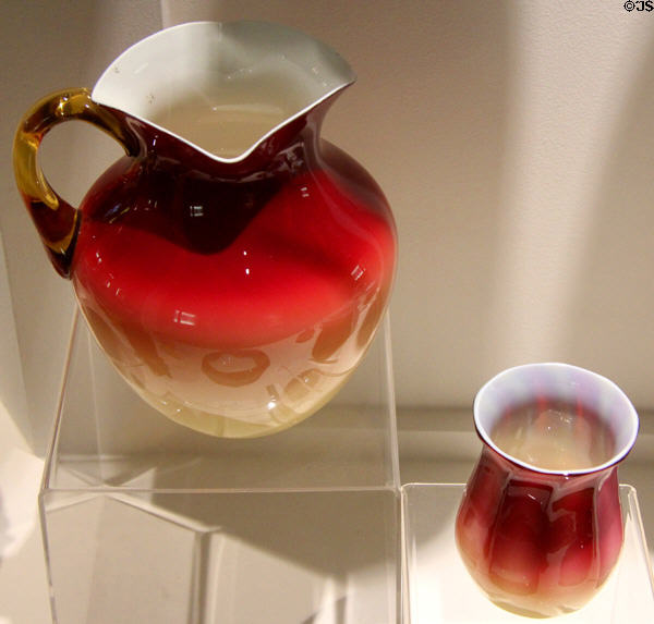 Wheeling Peach Blow or Coral pitcher (c1886) by Hobbs, Brockunier & Co. of Wheeling, WV beside Amberina glass vase (c1886) by New England Glass Co. of Cambridge, MA at Museum of American Glass. Milville, NJ.