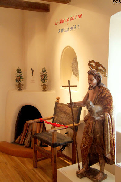 St John the Baptist Mexican sculpture (18thC), leather chair & gallery in Museum of Spanish Colonial Art. Santa Fe, NM.