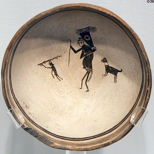 Mimbres classic black-on-white pottery bowl with woodgatherers (c1000-1150) at Maxwell Museum of Anthropology. Albuquerque, NM.