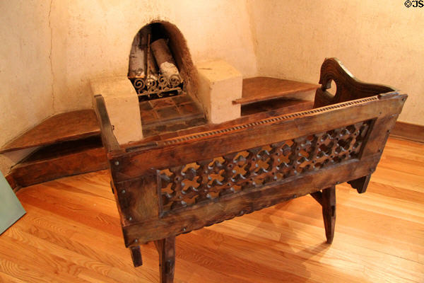 Bench before corner fireplace by Nicolai Fechin at Taos Art Museum. Taos, NM.