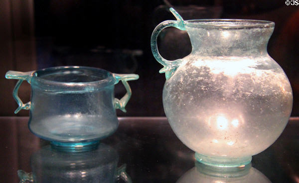 Early Roman cast glass cup with two handles (2nd half 1stC CE) & pitcher (1stC CE) at Corning Museum of Glass. Corning, NY.