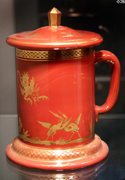 Covered red Hyalith glass mug (c1830-40) probably by glassworks of count of Buquoy of Southern Bohemia at Corning Museum of Glass. Corning, NY.