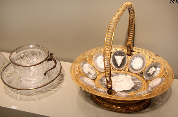 English glass basket with sulphides (c1820-30) prob. Falcon Glassworks of Apsley Pellatt of London beside French glass cup & saucer (early 19thC) at Corning Museum of Glass. Corning, NY.