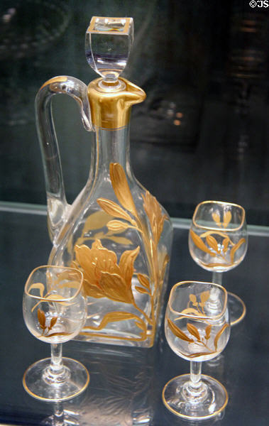 French glass trapezium-shaped gilded liqueur set (c1895) by Baccarat at Corning Museum of Glass. Corning, NY.