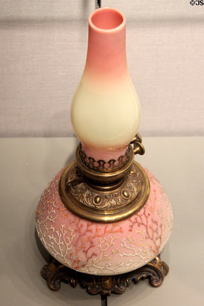 Burmese lamp with Coraline decoration (1887-90) by Mt. Washington Glass Co. (glass) & Pairpoint Manuf. Co. (mounts) of New Bedford, MA at Corning Museum of Glass. Corning, NY.