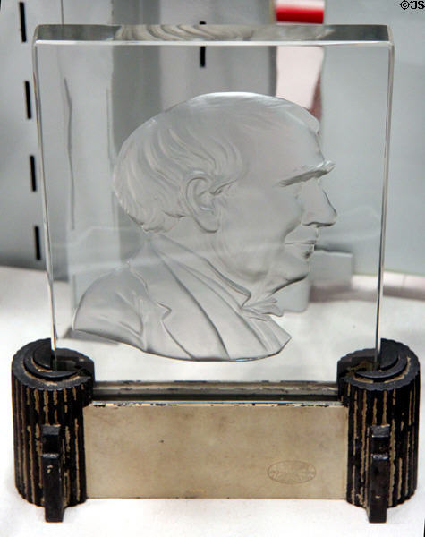 Glass plaque with face in profile by Frederick Carder of Steuben Glass at Corning Museum of Glass. Corning, NY.
