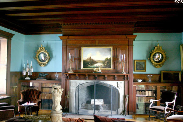 Fireplace in library in Clermont house with paintings & convex mirrors. Germantown, NY.