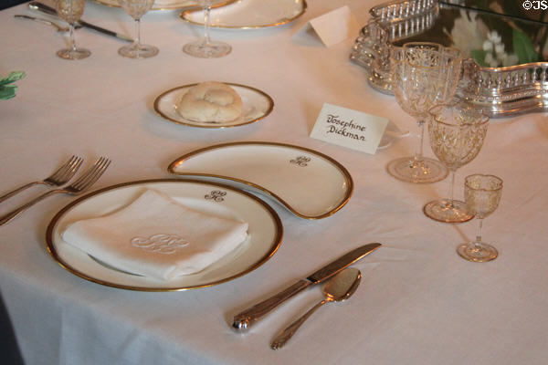 Dinner plate, crescent shaped plate & linen napkin each with George Eastman initials at Eastman House. Rochester, NY.