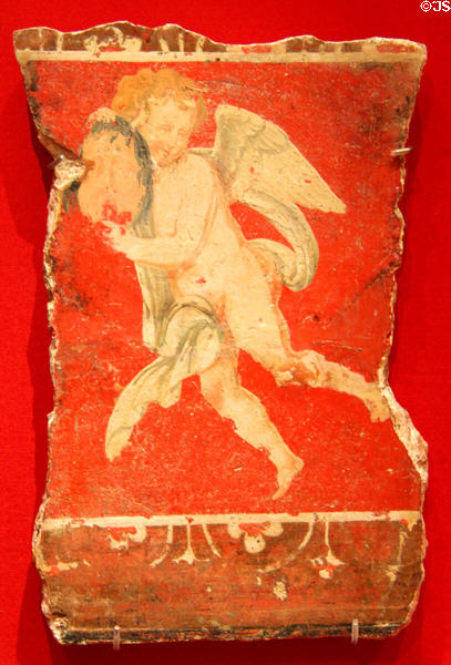 Roman painted plaster fresco with Cupid holding mask (before 79 CE) made in Egypt at Memorial Art Gallery. Rochester, NY.