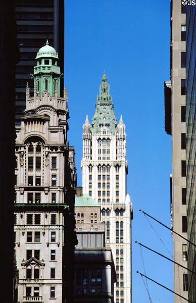 Looking up Broadway to Trinity Building (1907) (green dome) & Woolworth Building (spire). New York, NY.
